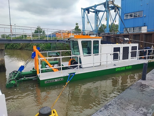 dredgers remove sand from settling ponds